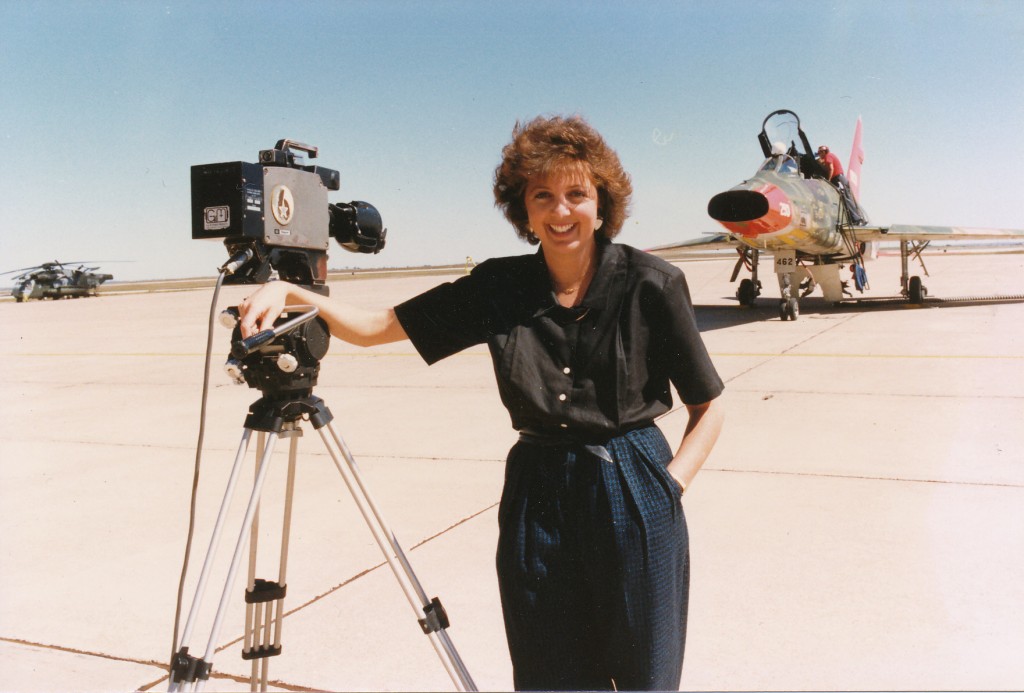 Jane at work reporting from an airport runway, with plane in background
