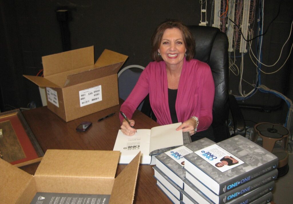 Jane Mitchell signing copies of her book